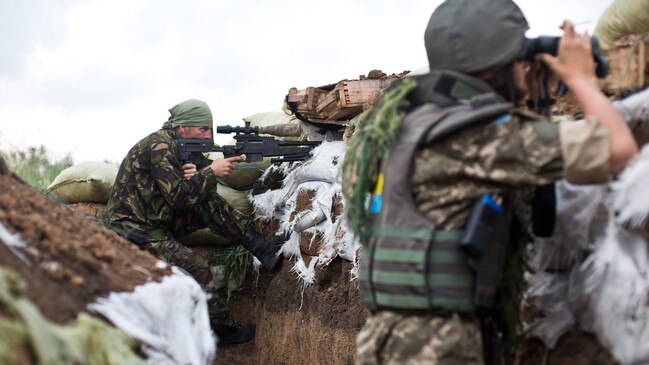 A Ukrainian sniper takes aim at Russian positions.