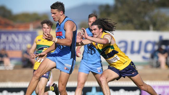 Sturt’s Ash Johnson kicks a goal under pressure from Eagle Ben Jungfer at Woodville Oval in round one. Picture: Dean Martin