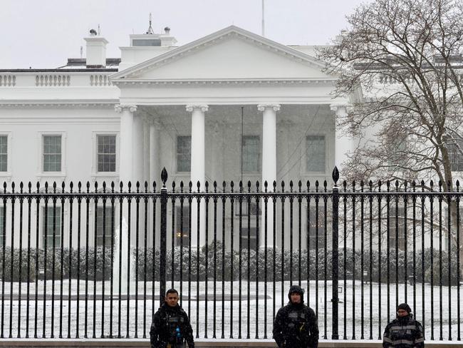 US Secret Service agents stand under the snow in front of the White House in Washington, DC, on January 15, 2024. Cold weather has gripped a large swath of the US, as Iowa, the first-in-nation primary state, holds the Republican caucus in frigid conditions. (Photo by Daniel SLIM / AFP)