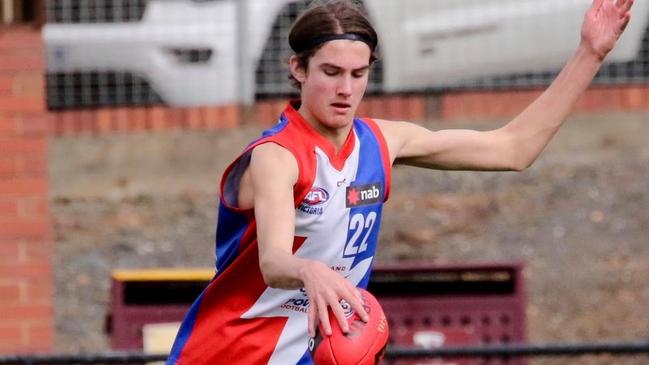 Zach Reid takes a kick for Gippsland Power.