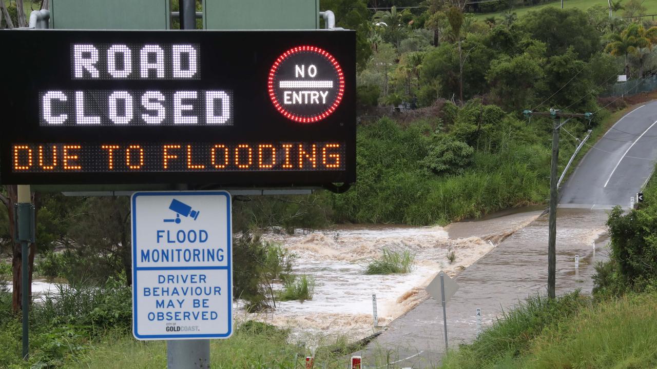 Water pours over Clagriba Rd weir on the Gold Coast. Picture Glenn Hampson