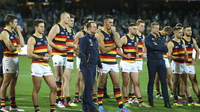 Don Pyke and Taylor Walker stand with the rest of the team after the loss. Picture Sarah Reed