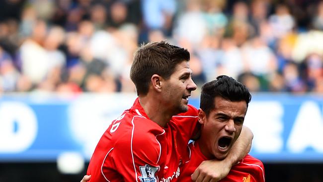 Philippe Coutinho of Liverpool celebrates with teammate Steven Gerrard.
