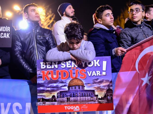 A young boy leans on a sign reading ‘There is no you or me, there is Jerusalem’ during a demonstration against the US and Israel in Istanbul. Picture: AFP/Yasin Akgul