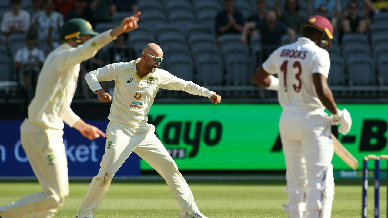 Nathan Lyon (C) took his third second innings five-for. Picture: Colin Murty/AFP