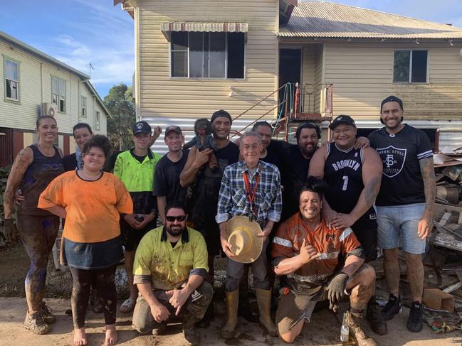 Bill Walsh, 69, surrounded by family friends who helped clean up his Lismore home after he was rescued from raging floodwaters on February 28, 2022.