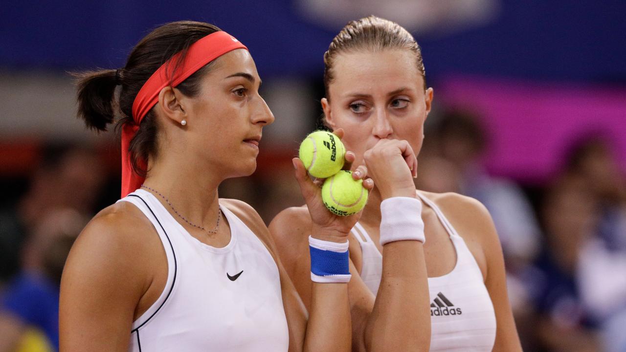 France's Kristina Mladenovic (R) and Caroline Garcia react during the fifth rubber of the Fed Cup tennis semi-final match.