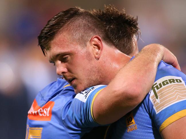 Ross Haylett-Petty is embraced by his brother Dane after playing his first game for the Force.