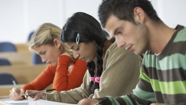 Three Students Taking a Test. University, education, schooling, exam. Generic, Thinkstock