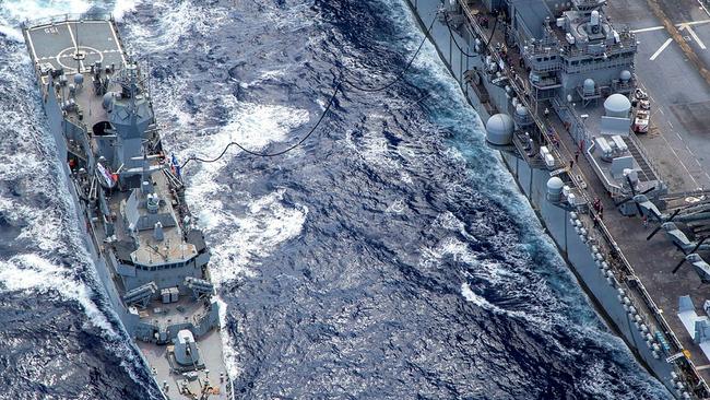 HMAS Ballarat (left) and USS America conduct a replenishment at sea off the coat of Queensland, during Exercise Talisman Sabre 2021. Picture: LSIS Ernesto Sanchez/ADF