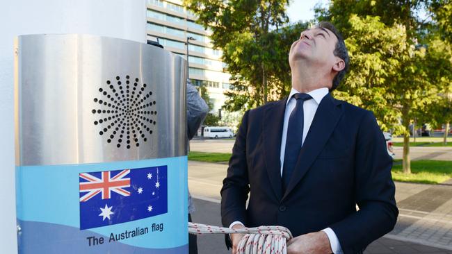 Premier Steven Marshall lowers the Australian flag in Victoria Square. Picture: Brenton Edwards/AAP