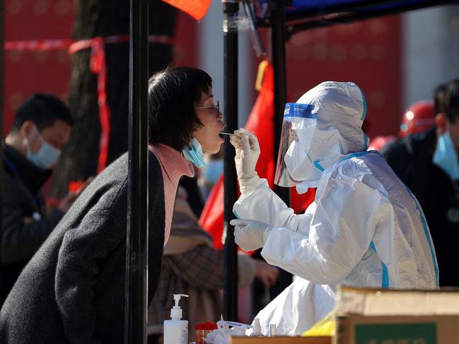 Testing a resident for coronavirus in Xi'an, in China's northern Shaanxi province. Over 13 million people were ordered to stay home to fight a growing Covid-19 outbreak. Picture: AFP / China OUT