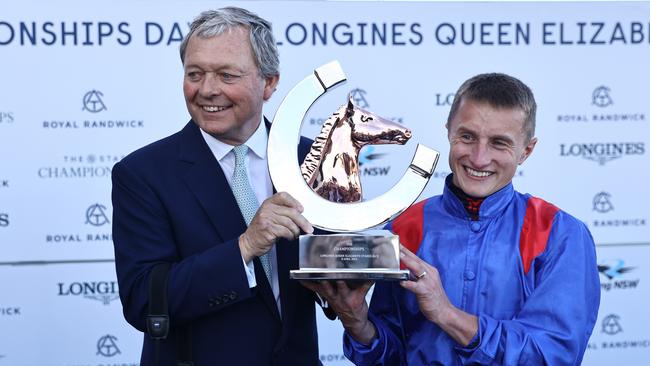 Trainer William Haggas (left) and jockey Tom Marquand hold aloft the Queen Elizabeth Stakes trophy won last year by Dubai Honour. Picture: Jeremy Ng / Getty Images