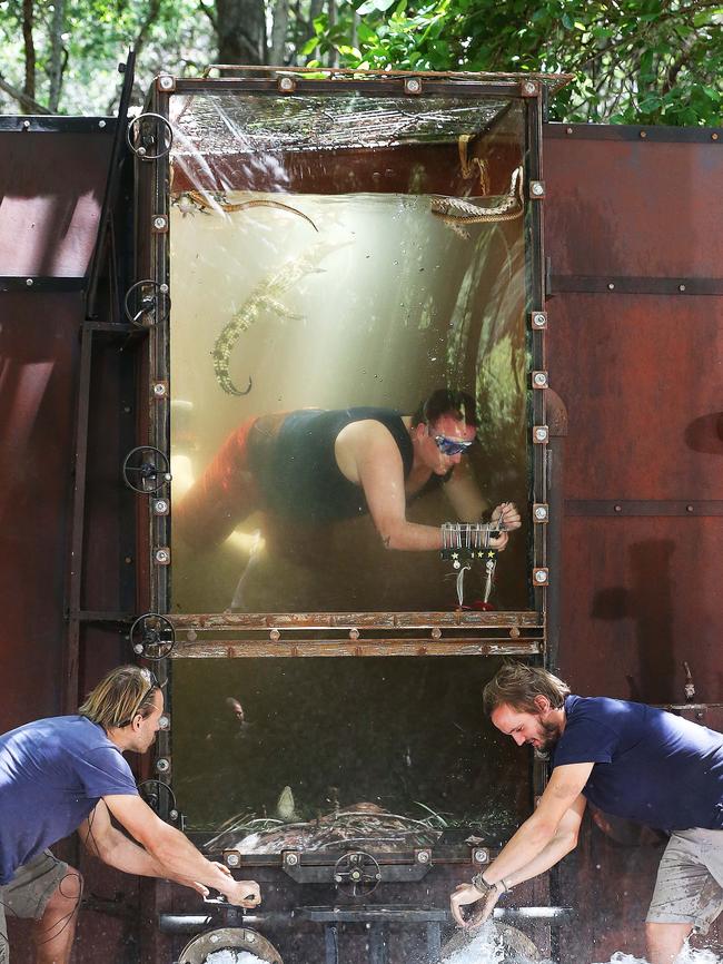 J. Mo tries to unlock the chains in the Flash Flood Tucker Trial. Picture: Channel 10