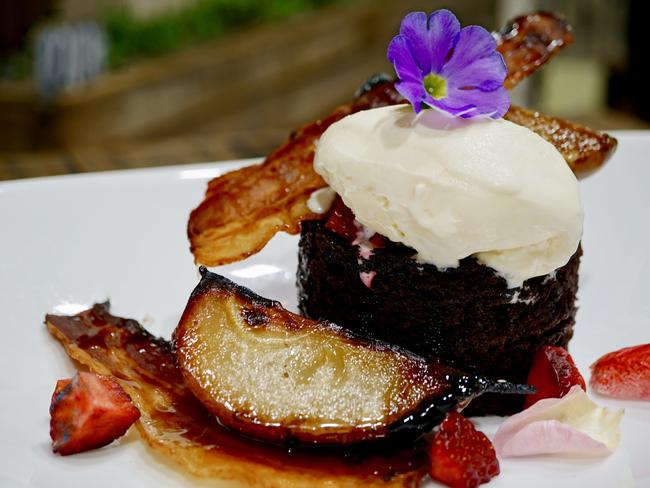 The Silly Tart Kitchen’s dark chocolate and bourbon cake with candied house-made bacon, brulee pear and bacon-fat ice cream. Picture: Supplied