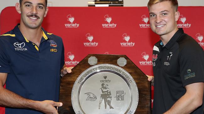 Crows co-captain Taylor Walker and Port Adelaide co-captain Ollie Wines hold the Variety Showdown Shield for the 46th contest. Picture SARAH REED