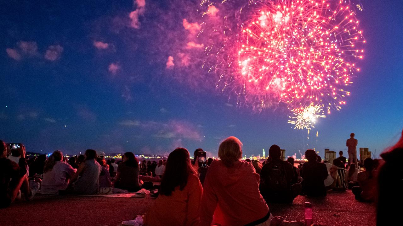 People watch the fireworks in front of the Statue of Liberty to mark New York state reaching a 70 per cent vaccination rate. Picture: Alexi Rosenfeld/Getty Images