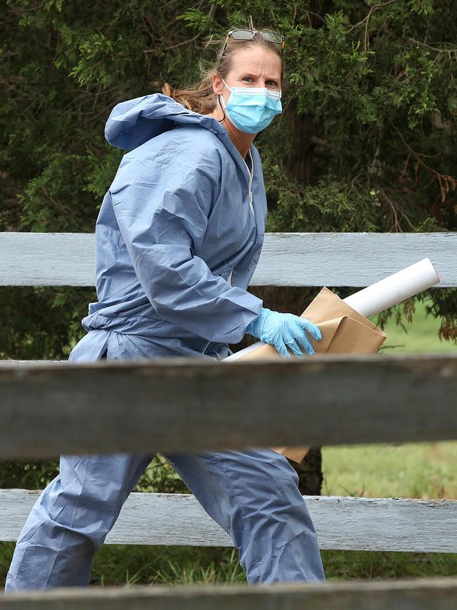 Police remove evidence from a house on Patullos Rd, Lara where a man was killed. Picture: Alison Wynd