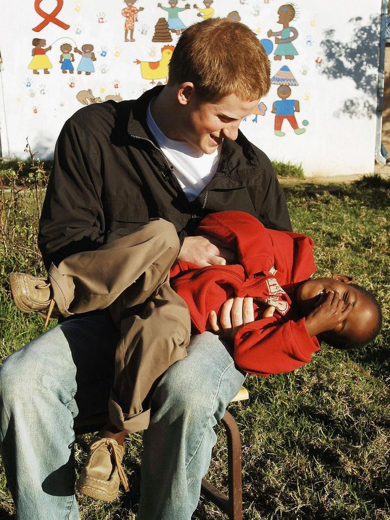 Prince Harry plays with Mutsu Potsane in the grounds of the Mants’ase children’s home while on a return visit to Lesotho on April 24, 2006 in southern Africa. Picture: Getty