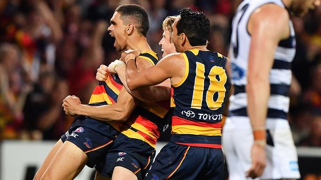 Charlie Cameron celebrates a goal with Rory Sloane and Eddie Betts.