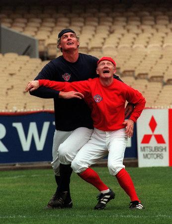 5: KEVIN BARTLETT. Kevin Bartlett (R) and Gary Dempsey, wearing 1897 uniforms, battle for the ball during the 1996 AFL Legends match at the MCG. Bartlett won five premierships with Richmond, and was named the club's best and fairest player five times. Picture: Ian Currie