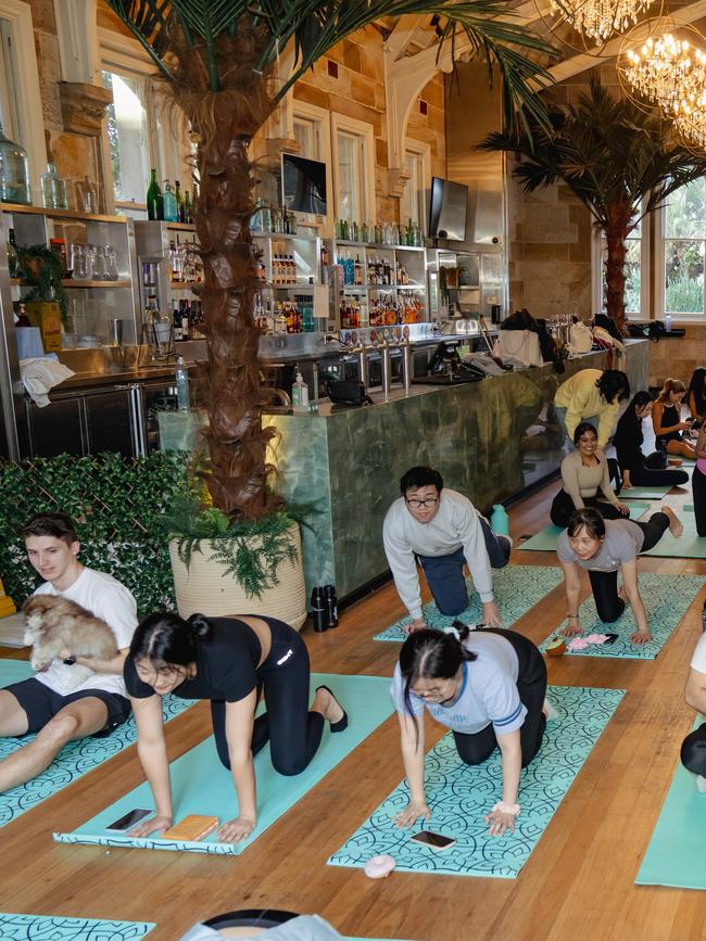 Others tried to participate in the yoga, while some were happy to play with the puppies. Picture: Greenwood Hotel/Supplied