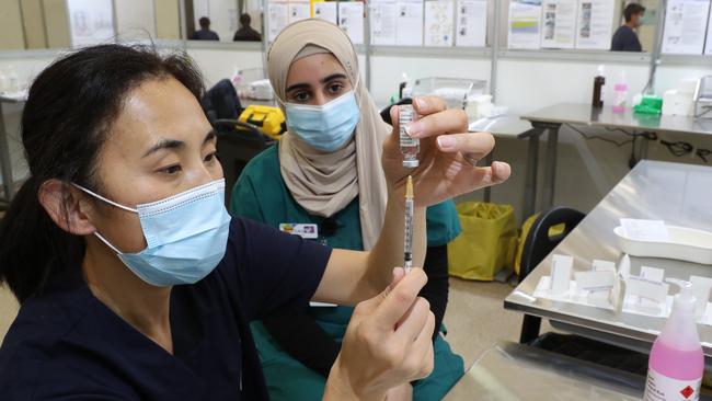 Staff prepare vaccinations at the new COVID-19 Vaccination Hub at the Melbourne Showgrounds on Monday. Picture: NCA NewsWire / David Crosling