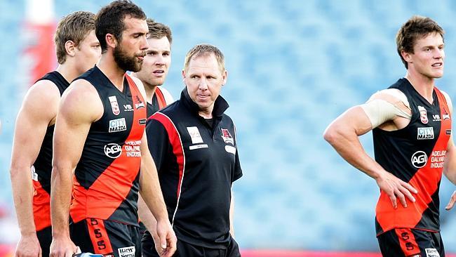 West Adelaide players and coach Andrew Collins leave the field after losing the 2013 preliminary final to North Adelaide. Pic...