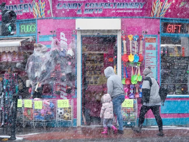 A family walk along the promenade as heavy snow falls in the sea side resort of Scarborough in North Yorkshire on February 27, 2018. A blast of Siberian weather sent temperatures plunging across much of Europe on Tuesday, causing headaches for travellers and leading to several deaths from exposure as snow carpeted palm-lined Mediterranean beaches. Picture: AFP