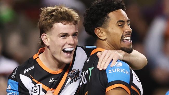 SYDNEY, AUSTRALIA - JUNE 23: Jahream Bula of the Tigers celebrates with team mates after scoring a try during the round 16 NRL match between Wests Tigers and Canberra Raiders at Campbelltown Stadium, on June 23, 2024, in Sydney, Australia. (Photo by Matt King/Getty Images)