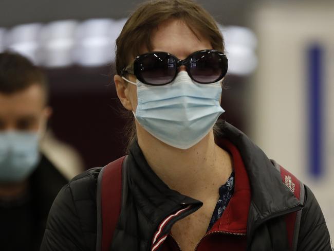 Travelers, wearing face masks, leave London's Underground Baker Street station, Tuesday, June 9, 2020. Wearing a face mask will become compulsory on the London TFL public transport service starting from June 15, 2020, as a safety measure to contrast the COVID-19 pandemic. (AP Photo/Frank Augstein)