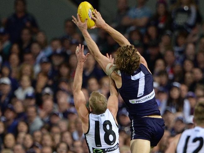 Nat Fyfe flies over Kane Cornes. Picture: Daniel Wilkins