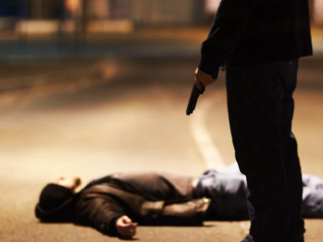 Generic crime Istock  -  Man lying on the ground after being shot by a gun-wielding criminal