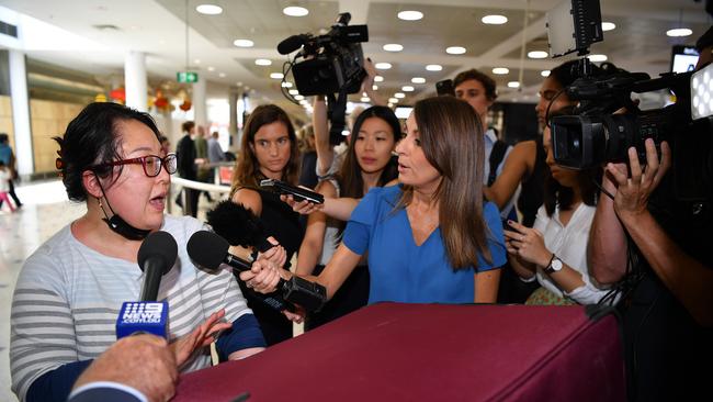 Reporters interview passengers arriving from Wuhan at Sydney International Airport on January 23, 2020 - exactly one year ago today - before masks and social distancing were part of daily life. Picture: Joel Carrett