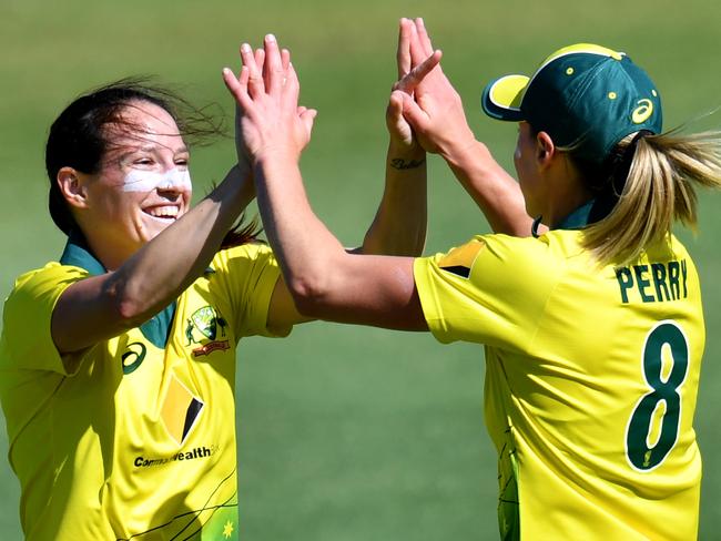 Megan Schutt (left) of Australia celebrates with Ellyse Perry (right) after getting the wicket of Jess Watkin of New Zealand during the second match of the Women's Twenty20 (T20) Series between Australia and New Zealand at the Allan Border Field in Brisbane, Monday, October 1, 2018. (AAP Image/Darren England) NO ARCHIVING, EDITORIAL USE ONLY, IMAGES TO BE USED FOR NEWS REPORTING PURPOSES ONLY, NO COMMERCIAL USE WHATSOEVER, NO USE IN BOOKS WITHOUT PRIOR WRITTEN CONSENT FROM AAP