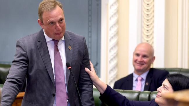 Queensland Premier Steven Miles receives a comforting hand from Industrial Relations Minister Grace Grace during parliament on Tuesday. Picture: Steve Pohlner