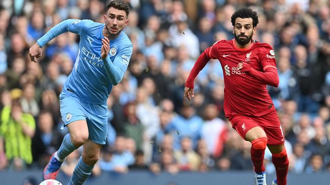 TOPSHOT - Liverpool's Egyptian midfielder Mohamed Salah (R) vies with Manchester City's French defender Aymeric Laporte during the English Premier League football match between Manchester City and Liverpool at the Etihad Stadium in Manchester, north west England, on April 10, 2022. (Photo by Paul ELLIS / AFP) / RESTRICTED TO EDITORIAL USE. No use with unauthorized audio, video, data, fixture lists, club/league logos or 'live' services. Online in-match use limited to 120 images. An additional 40 images may be used in extra time. No video emulation. Social media in-match use limited to 120 images. An additional 40 images may be used in extra time. No use in betting publications, games or single club/league/player publications. /