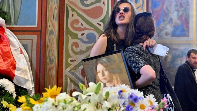 Women react near the coffin of Victoria Amelina during her funeral. Picture: Sergei SUPINSKY / AFP