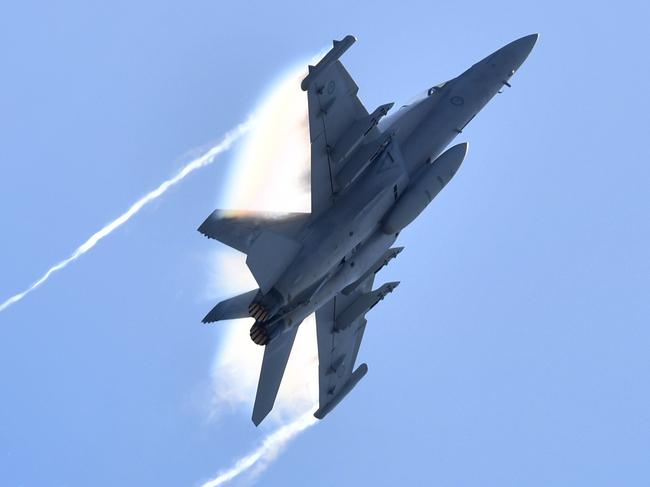 A Royal Australian Air Force EA-18G Growler flies over the Brisbane skyline. Picture: AAP