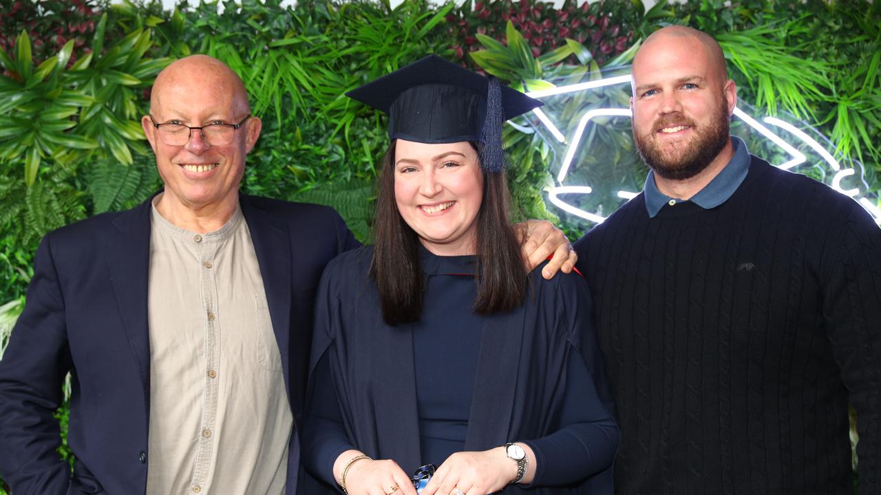 Deakin graduate Krystelle Raiser with father in law Chas Savage and husband Daniel Raiser. Picture: Alison Wynd