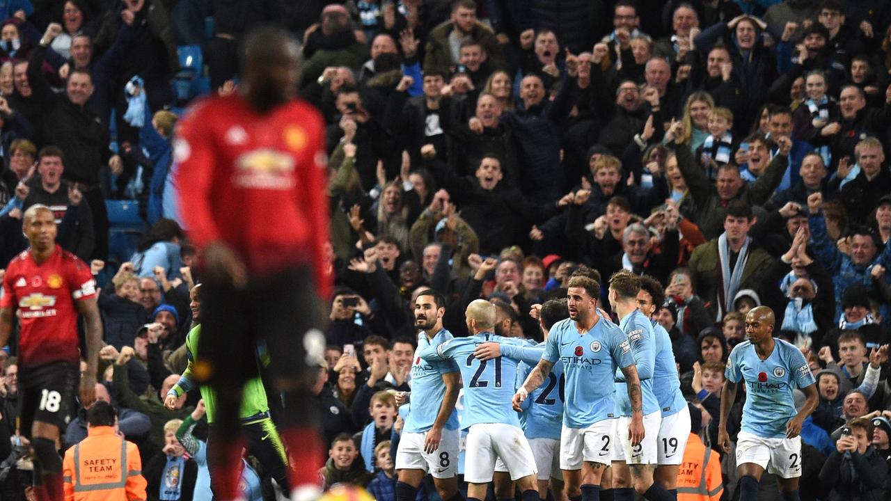 Manchester City's German midfielder Ilkay Gundogan celebrates with teammates