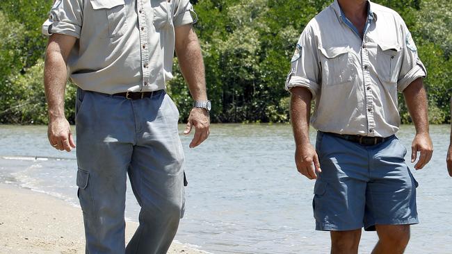 Clayton Enoch, Jarrad Mitchell and Andrew Coats, indigenous rangers of the Queensland Parks and Wildlife Service (Marine Parks Section) looks at a turtle at the rehabilitation centre in Cairns.