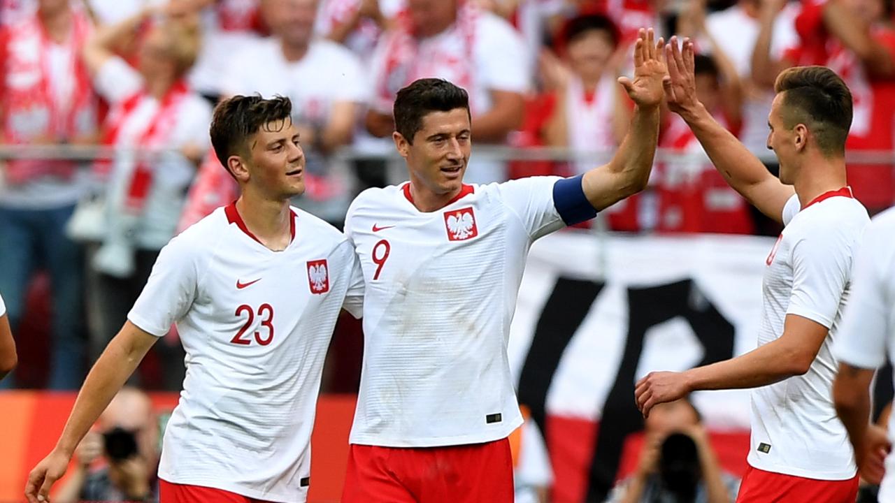 Poland's Robert Lewandowski (C), Dawid Kownacki (L) and Arkadiusz Milik react after Lewandowski scored a goal
