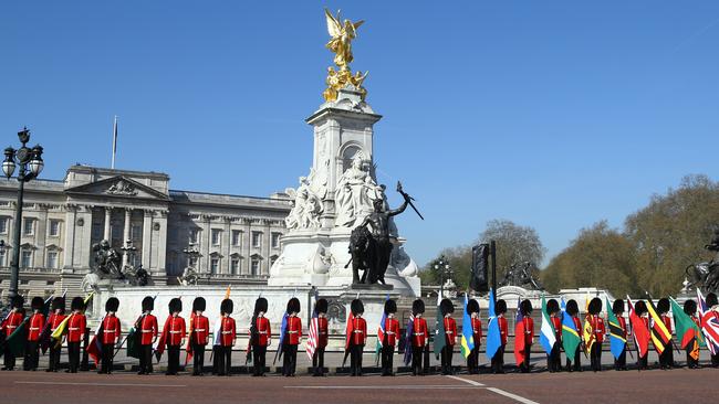 Soldiers of the Coldstream Guards carry flags of the 53 Commonwealth countries outside Buckingham Palace. Picture: Gareth Fuller/PA via AP.