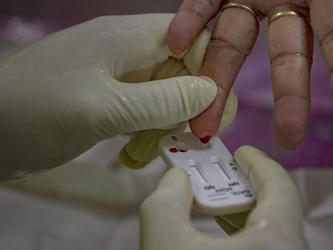 A medical worker takes blood from a woman to test for COVID-19 using a rapid antibody testing kit. Picture: Getty