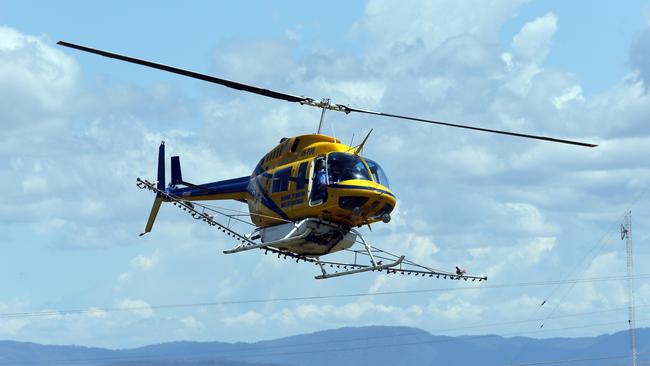 A helicopter used by Brisbane City Council for spraying mosquito breeding sites. Picture: Glenn Barnes