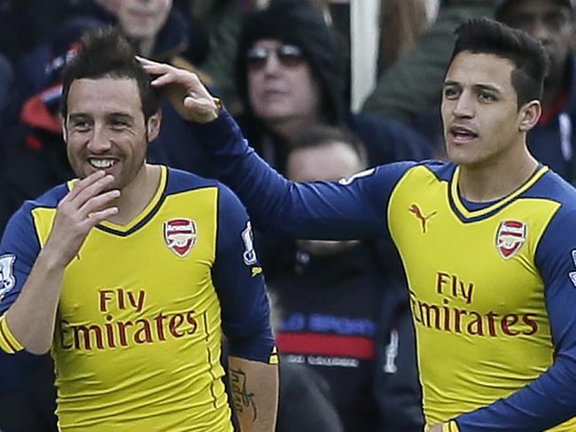 Arsenal’s Santi Cazorla, left, celebrates with Arsenal’s Alexis Sanchez, second left, after scoring a penalty during the English Premier League soccer match between Crystal Palace and Arsenal at Selhurst Park, London, Saturday, Feb. 21, 2015. (AP Photo/Tim Ireland)