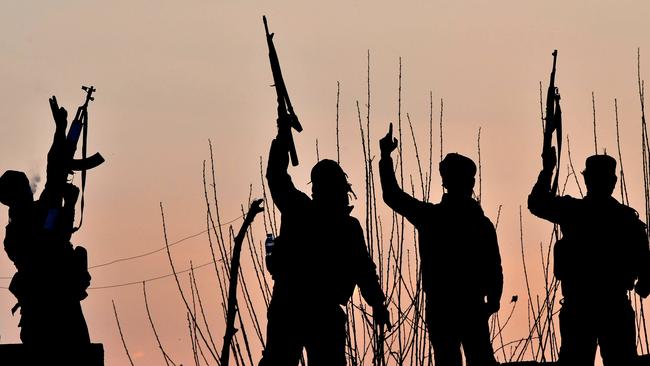 Syrian Democratic Forces (SDF) fighters celebrate after fighting Islamic State jihadists near the village of Baghouz in the eastern Syrian province of Deir Ezzor. Picture: AFP 