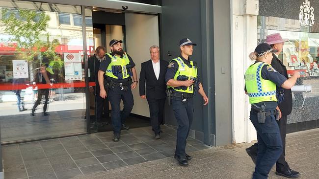 The arrest at NAB Launceston on December 7, 2022 of Extinction Rebellion protesters Graham Bailey (left), Pr Jeff McKinnon (centre) and Dr Scott Bell (right). Picture: XRNT