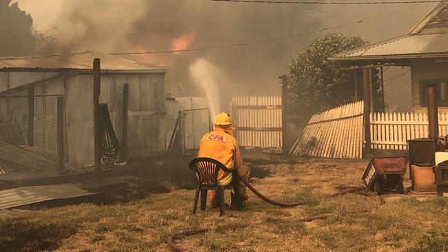 Tim Barry from the Ullina CFA protecting a home in Raglan just after 5pm on Thursday. Photo: Russell Keith